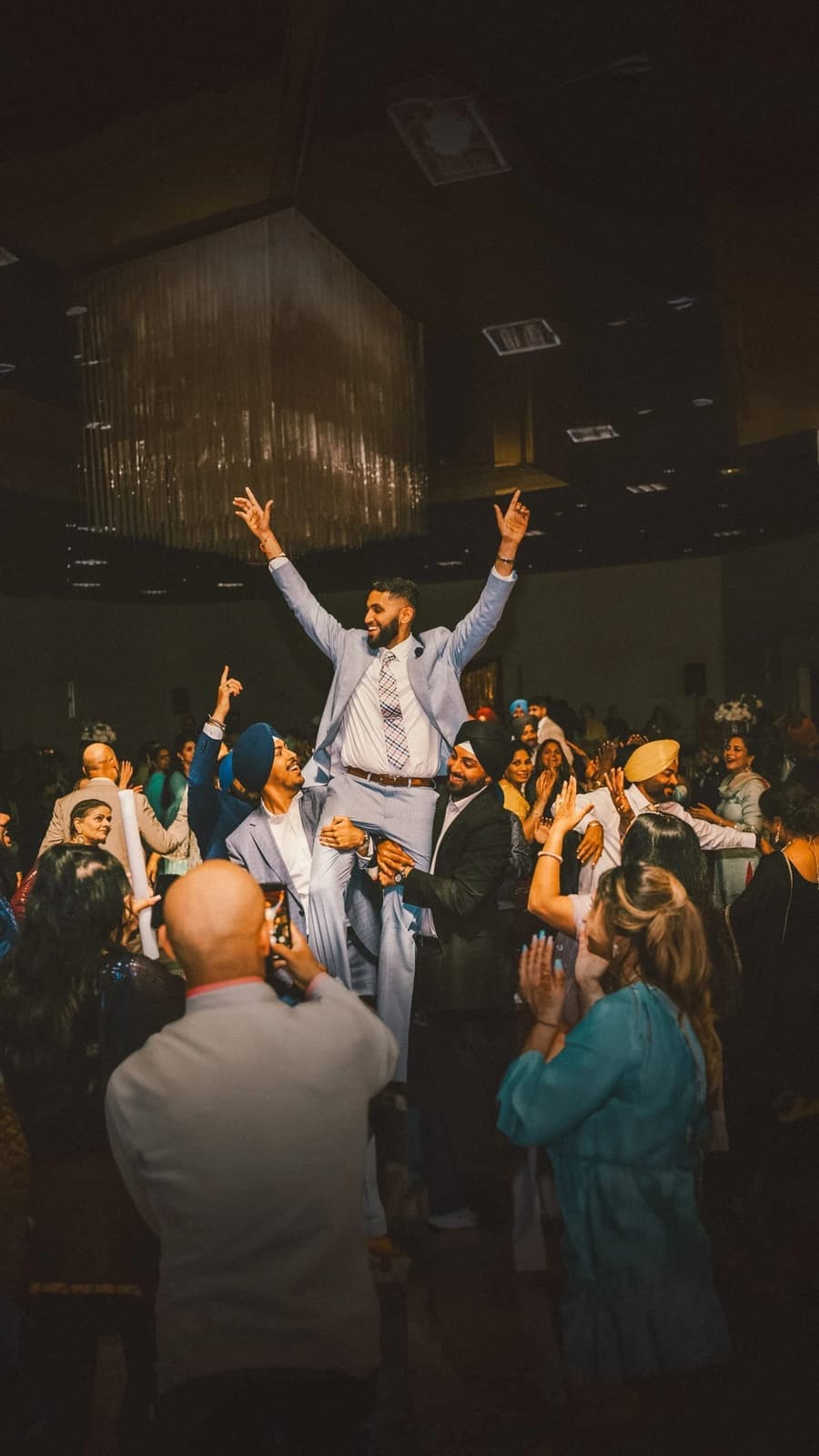 Packed Amped Entertainment dance floor lit up during a celebration