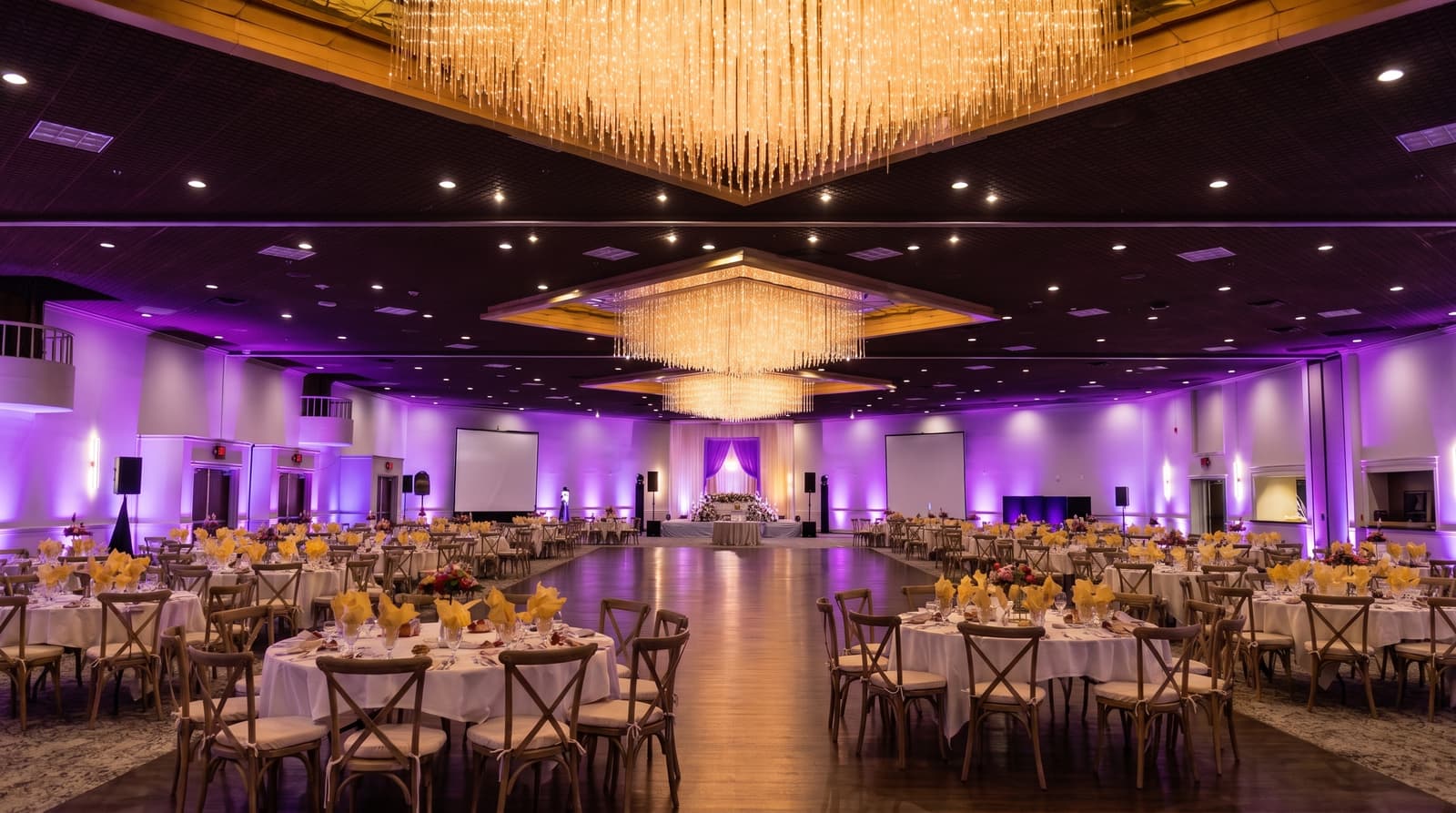The same wedding ballroom transformed with rich purple Amped uplighting